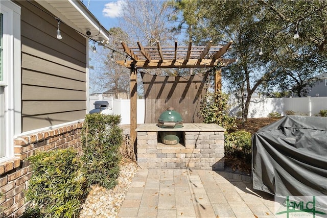 view of patio / terrace featuring grilling area and a pergola