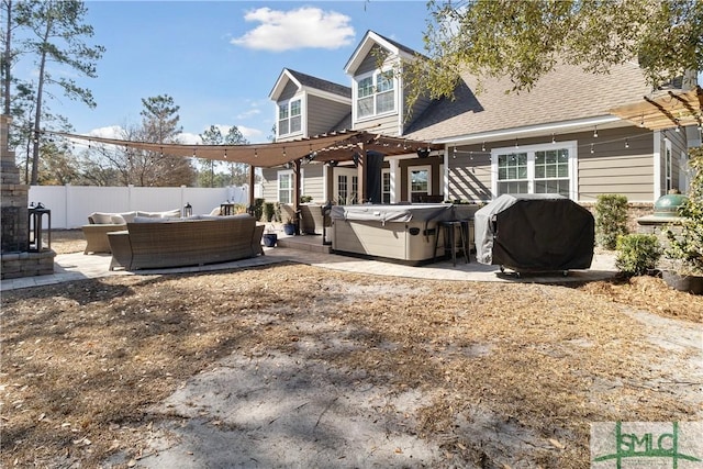 back of house featuring an outdoor living space, a pergola, a patio area, and a hot tub