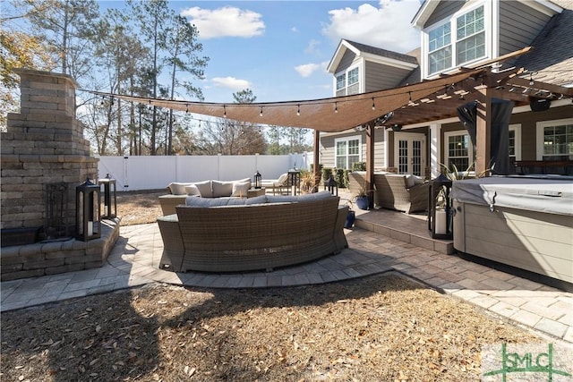 view of patio with a hot tub, an outdoor hangout area, and a pergola