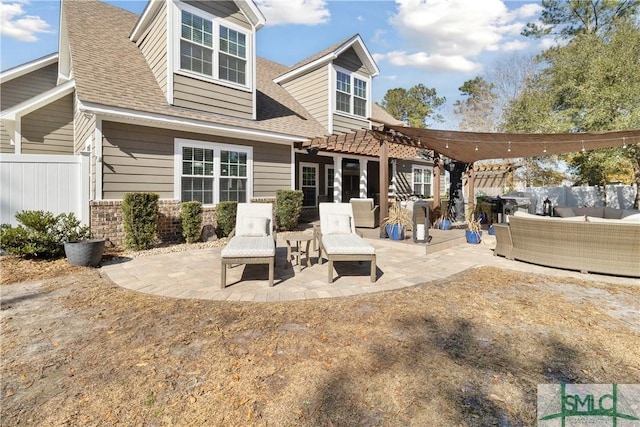 rear view of house featuring an outdoor living space, a pergola, and a patio