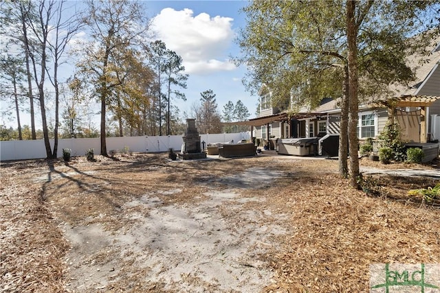 view of yard featuring a hot tub and an outdoor hangout area