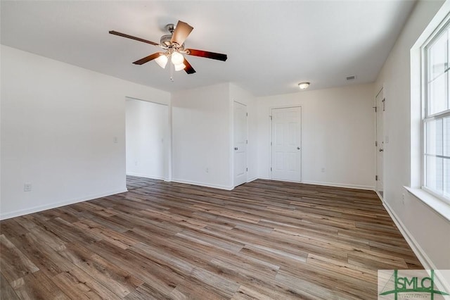 spare room featuring hardwood / wood-style floors and ceiling fan