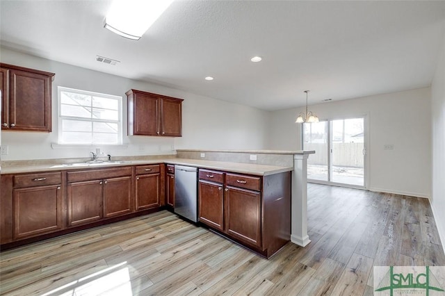 kitchen featuring sink, hanging light fixtures, light hardwood / wood-style flooring, dishwasher, and kitchen peninsula