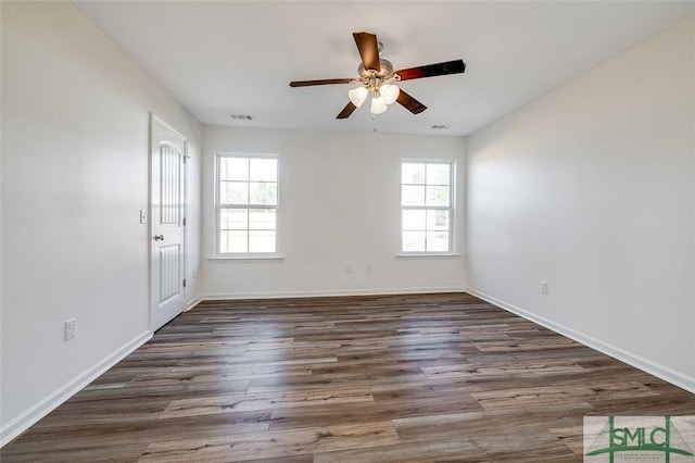 spare room with dark hardwood / wood-style floors and ceiling fan