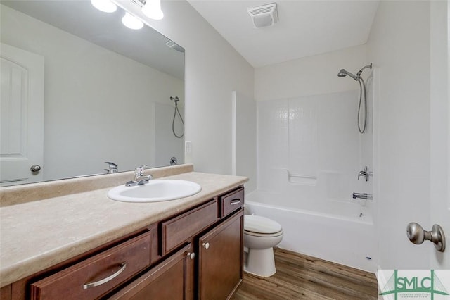 full bathroom featuring vanity, toilet, tub / shower combination, and hardwood / wood-style floors