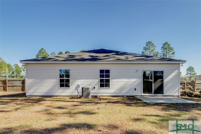 rear view of house featuring a patio, a yard, and cooling unit