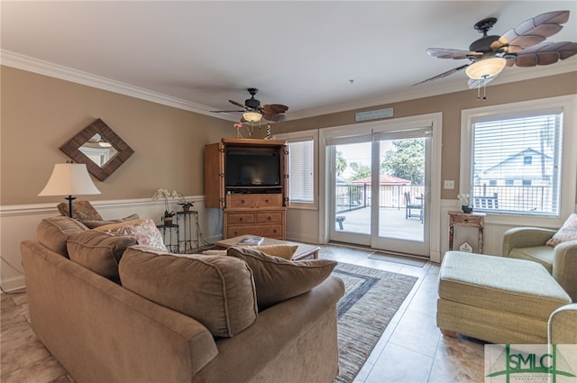 tiled living room with ornamental molding and ceiling fan