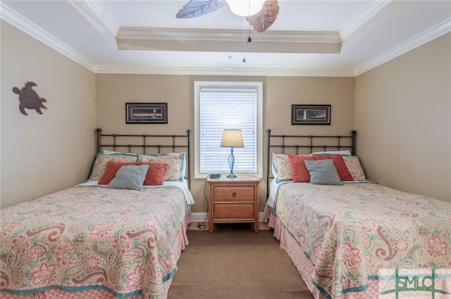 carpeted bedroom featuring crown molding, a tray ceiling, and ceiling fan