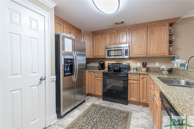 kitchen with stainless steel appliances, sink, and light stone counters