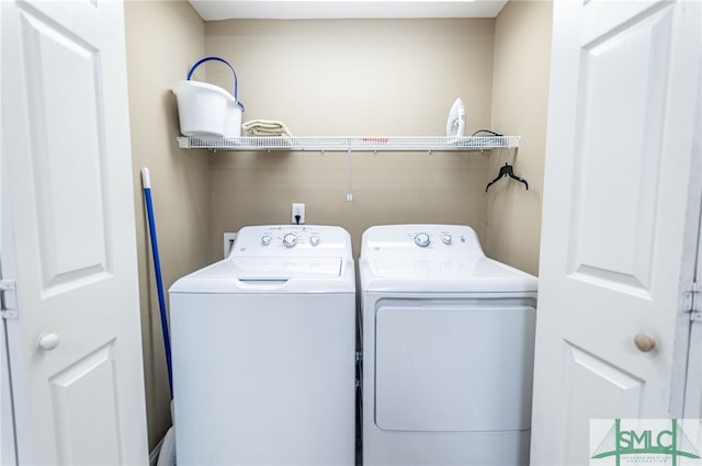 clothes washing area with washing machine and clothes dryer