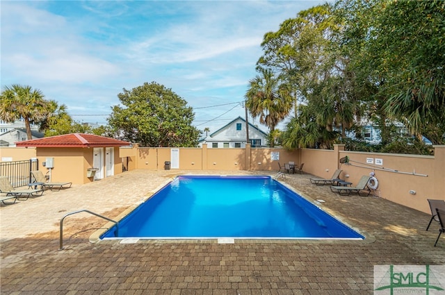 view of swimming pool featuring a patio area