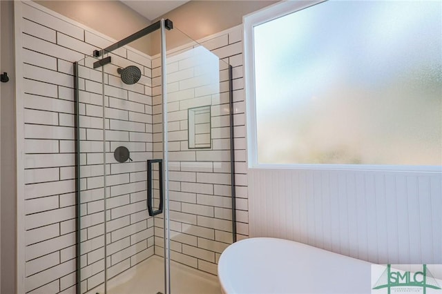 bathroom featuring a shower with door