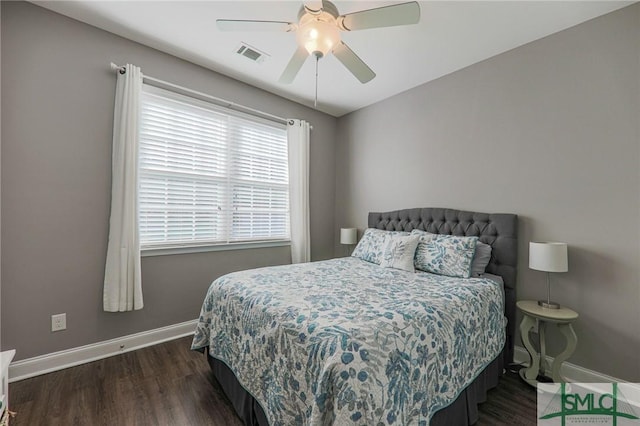 bedroom with dark hardwood / wood-style floors and ceiling fan