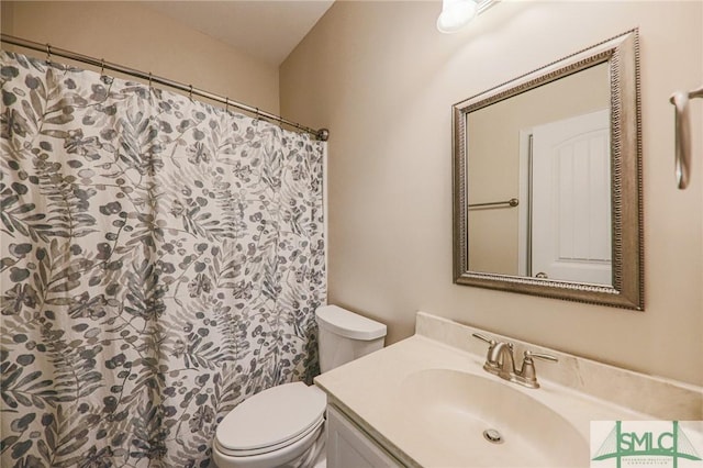 bathroom featuring vanity and toilet