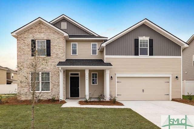 craftsman-style house with a garage and a front lawn