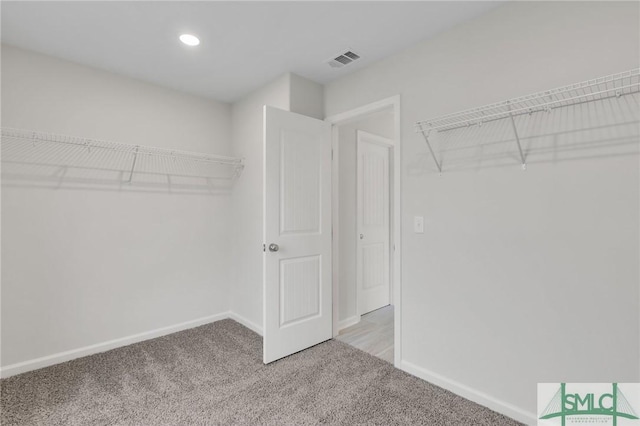 spacious closet with light carpet and visible vents