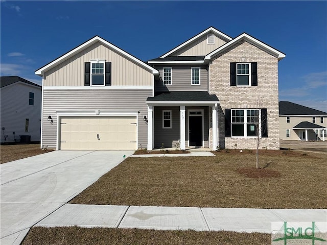 craftsman house featuring a front yard, brick siding, driveway, and an attached garage