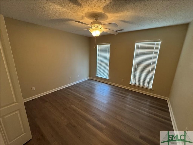 spare room with ceiling fan, dark hardwood / wood-style flooring, and a textured ceiling