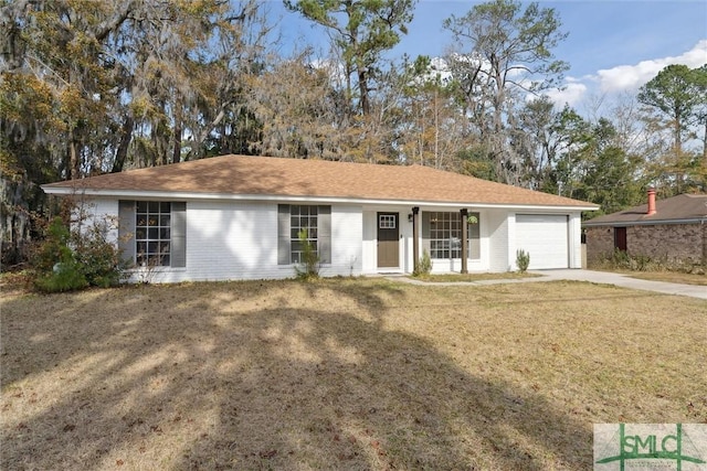 ranch-style house featuring a garage and a front lawn