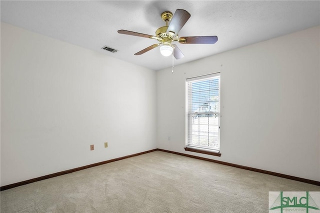 carpeted empty room featuring ceiling fan