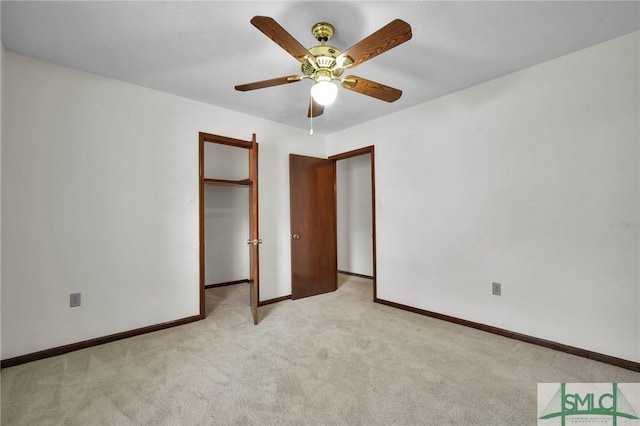 unfurnished bedroom featuring light colored carpet and ceiling fan