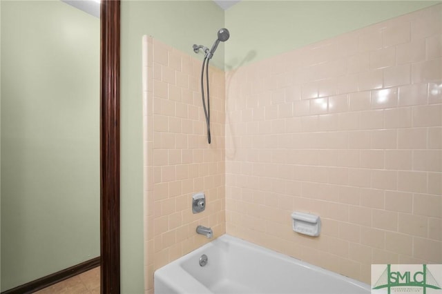 bathroom with tiled shower / bath combo and tile patterned flooring