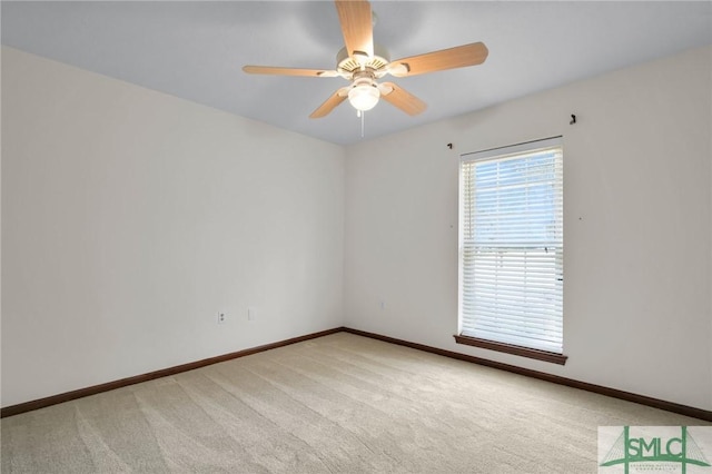 carpeted spare room with ceiling fan