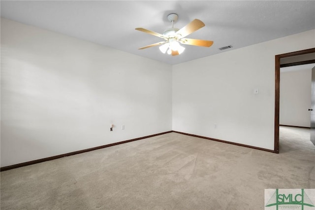 empty room with light colored carpet and ceiling fan