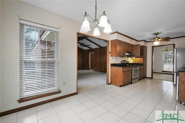 kitchen with stainless steel appliances, ceiling fan with notable chandelier, pendant lighting, and light tile patterned floors