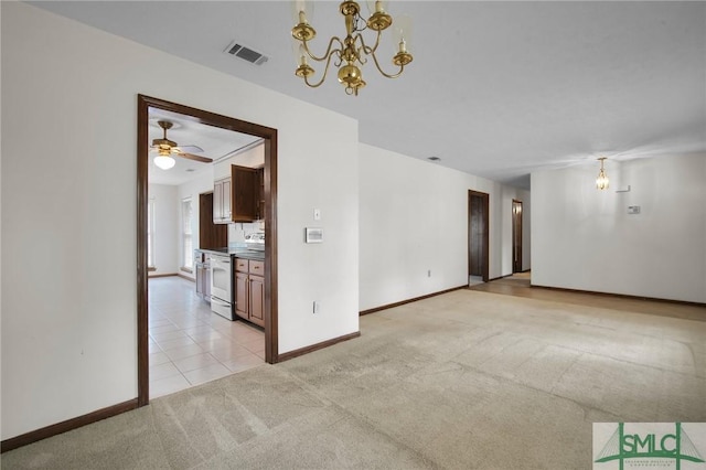 unfurnished room with light carpet and a chandelier