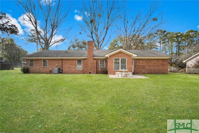 rear view of house featuring cooling unit, a yard, and a patio