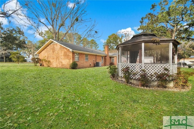 exterior space featuring central AC unit and a sunroom