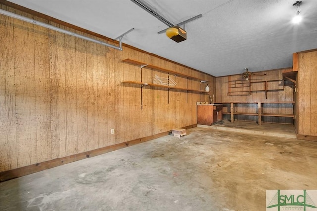 garage with a garage door opener and wooden walls