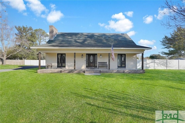 rear view of property with a lawn and a porch