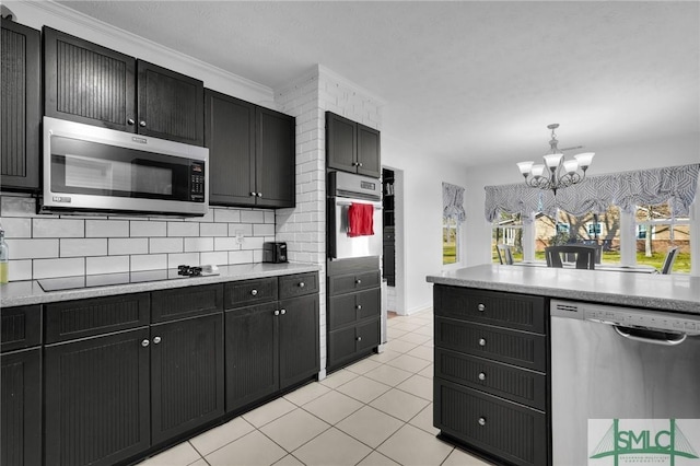 kitchen with light tile patterned flooring, a chandelier, pendant lighting, stainless steel appliances, and backsplash