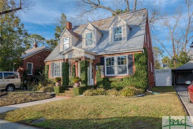 620 E 51st St, Savannah, GA 31405 - new england style home featuring a chimney, brick siding, and a gate