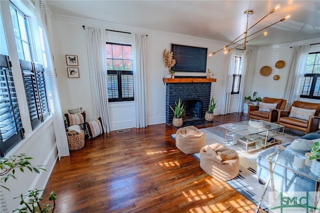620 E 51st St, Savannah, GA 31405 - living area featuring ornamental molding, wood finished floors, a brick fireplace, and baseboards
