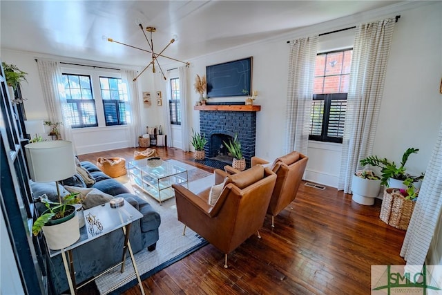 living room featuring a fireplace, ornamental molding, and dark hardwood / wood-style floors