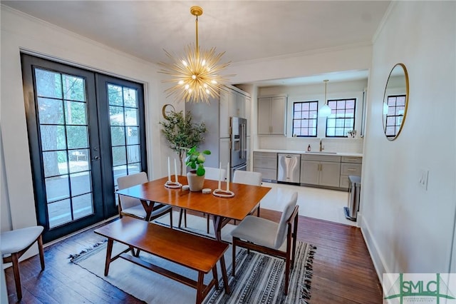 dining room featuring sink, crown molding, and dark hardwood / wood-style floors