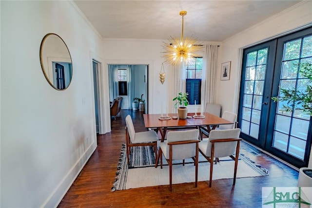 dining area featuring crown molding, dark hardwood / wood-style floors, a notable chandelier, and french doors