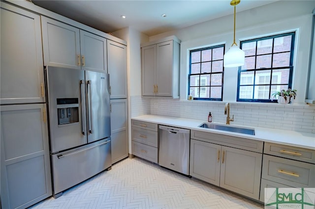 kitchen featuring appliances with stainless steel finishes, sink, and gray cabinetry