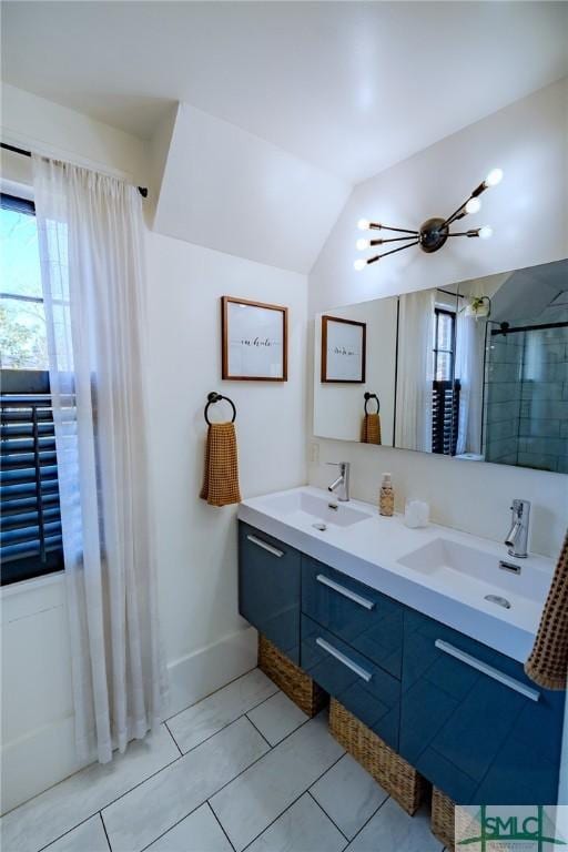 bathroom featuring lofted ceiling, vanity, and a wealth of natural light