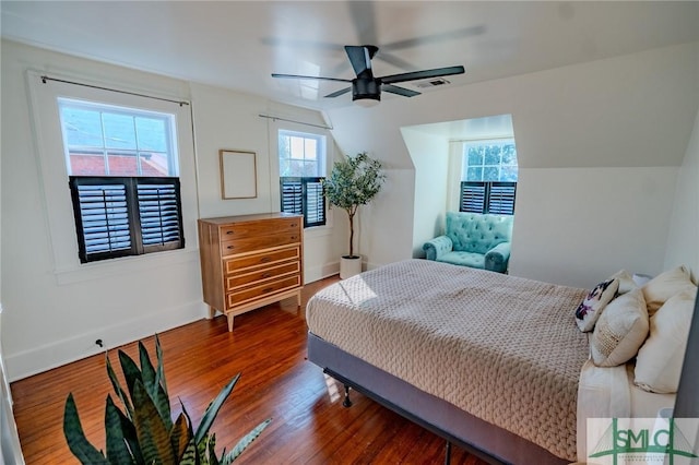 bedroom with dark hardwood / wood-style flooring, lofted ceiling, and ceiling fan