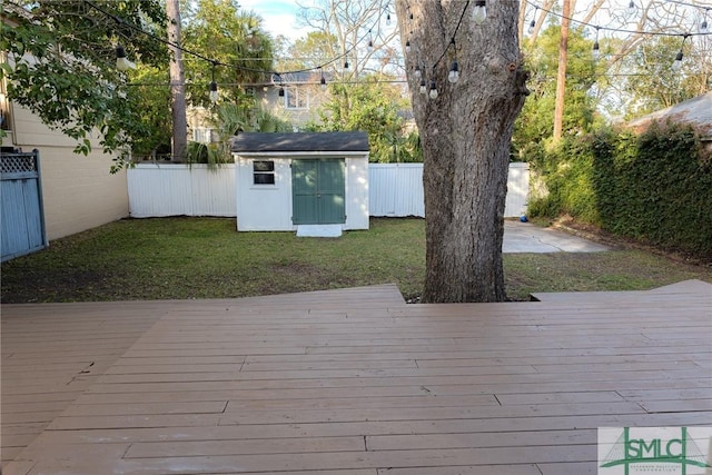 deck featuring a storage shed and a lawn