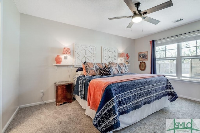 bedroom with a ceiling fan, carpet flooring, visible vents, and baseboards