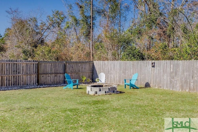 view of yard with a fire pit and a fenced backyard