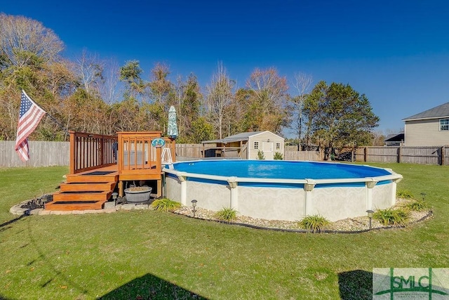 view of pool featuring a fenced in pool, a lawn, a fenced backyard, a wooden deck, and an outdoor structure