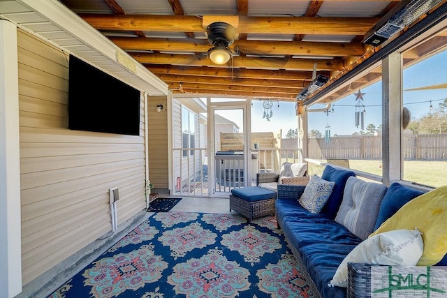 sunroom / solarium featuring a ceiling fan