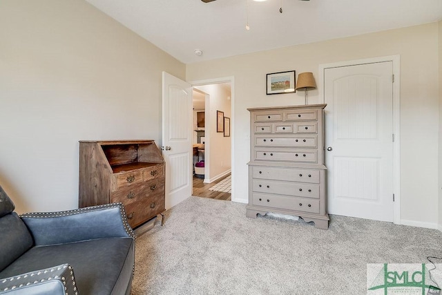 sitting room with ceiling fan, carpet, and baseboards