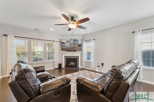 living room featuring hardwood / wood-style floors and ceiling fan